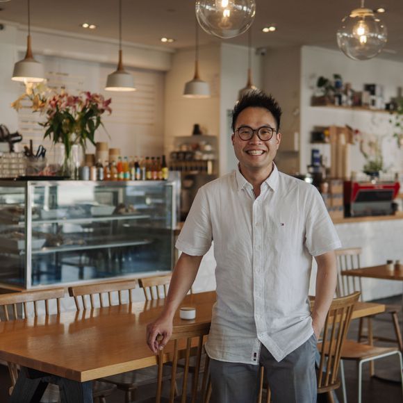 Dove Chen standing in his Hamilton Cafe.