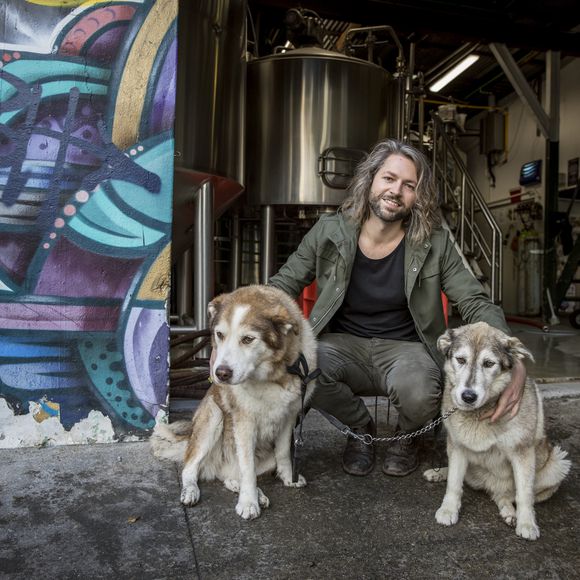 Jos and his two dogs outside Garage Project.