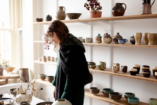 A customer browsing ceramics at Ata.