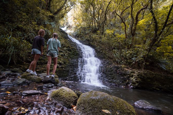 Two woman looking at Waterfall at Ross Creek.