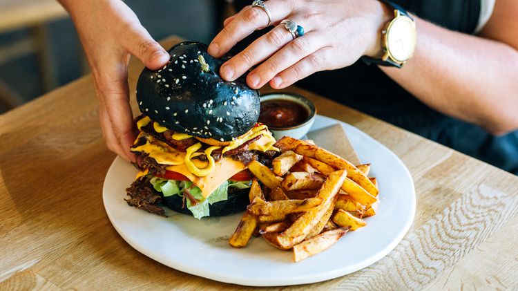 A burger and chips on a plate.